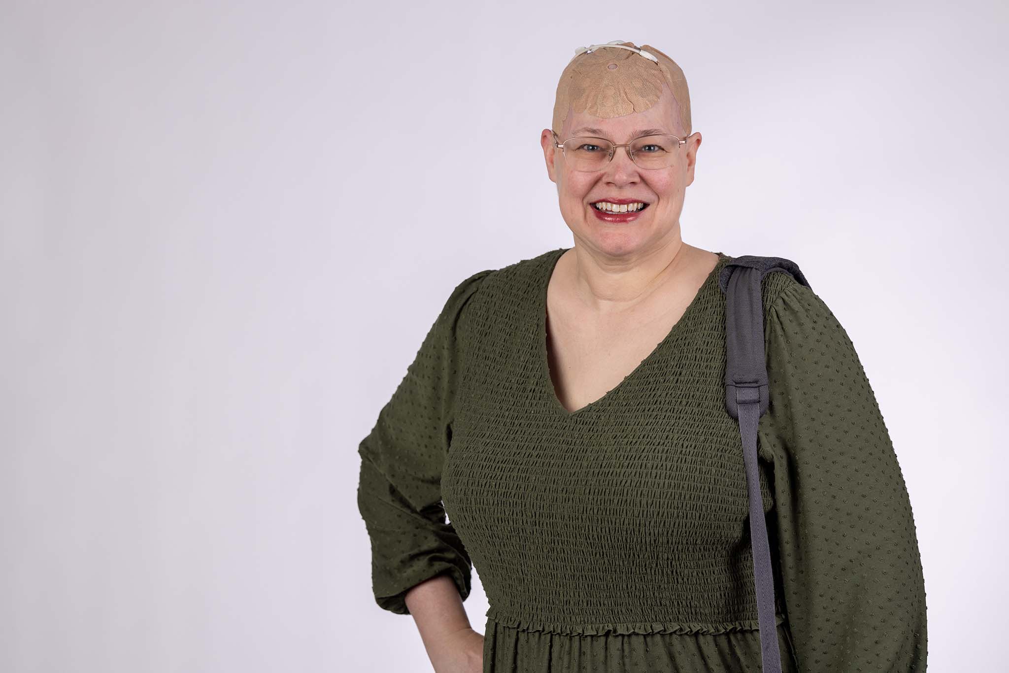Jeanneane poses while wearing Optune Gio over one shoulder.